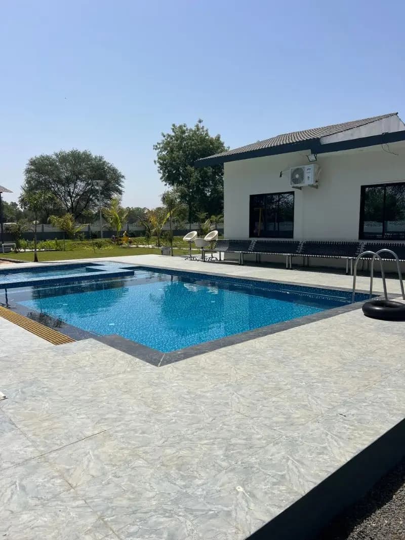 Poolside loungers at a farmhouse near Ahmedabad