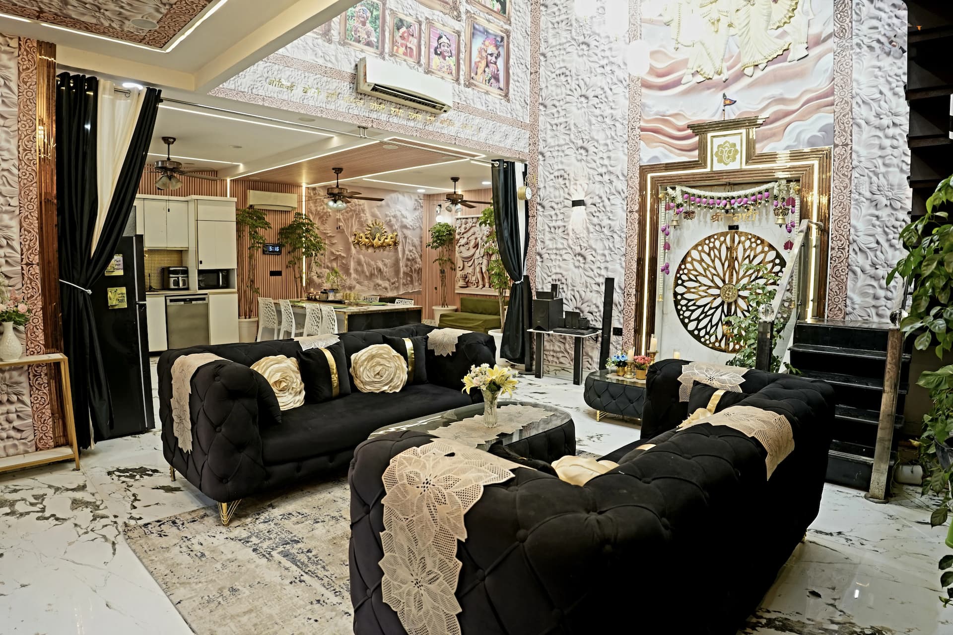 Indoor lounge with dark sofas and a stone wall at a farmhouse in Noida