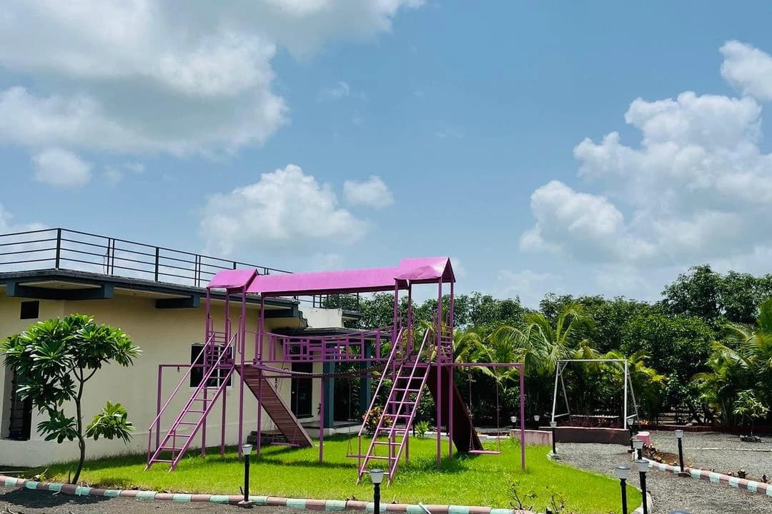 Children's playground with slides beside a lawn at a resort