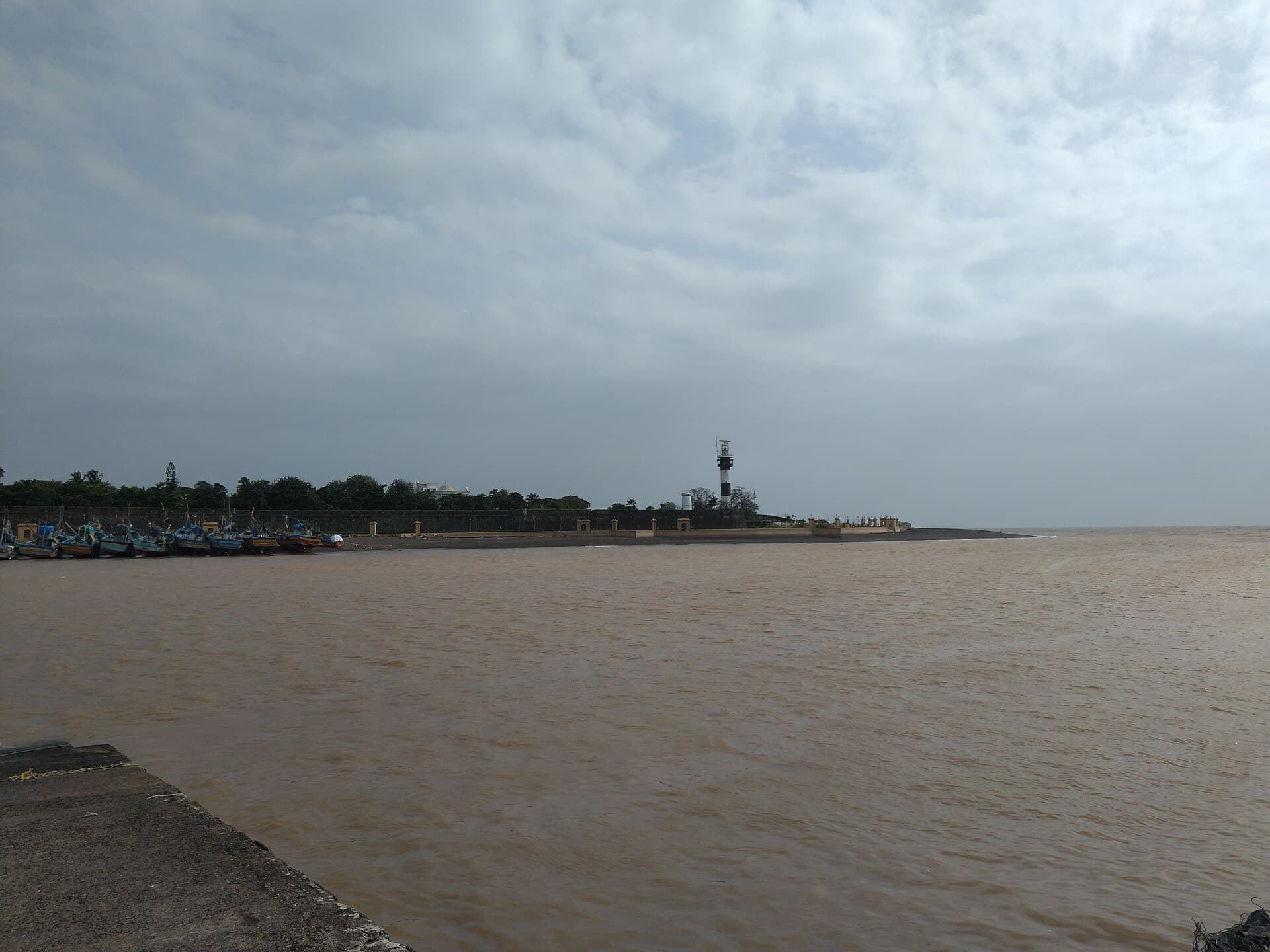 Moti Daman fort wall and lighthouse at the mouth of the Damanganga river