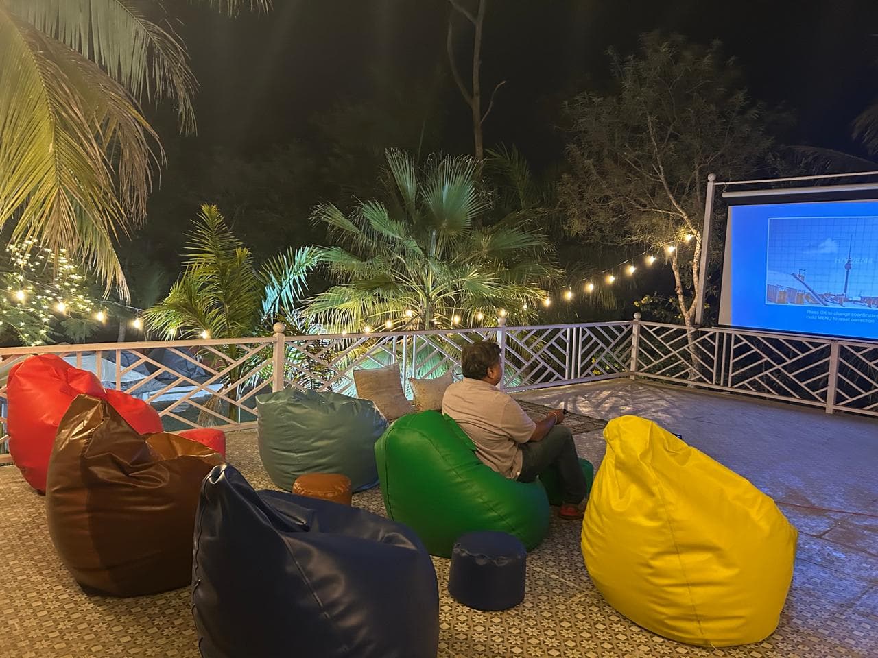 Outdoor seating with bean bags and festoon lights at a villa in Ahmedabad