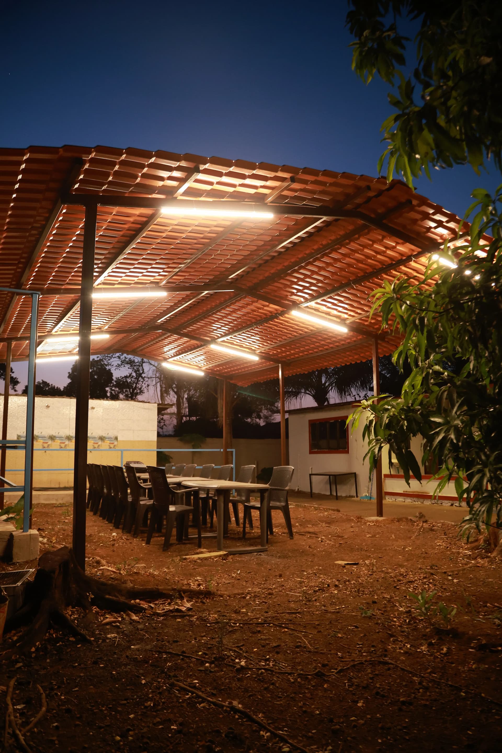 Covered outdoor dining pavilion at a villa in Karjat